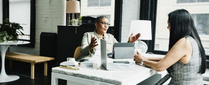 Business mentor coaching a professional during a leadership mentoring session focused on career growth, knowledge sharing, and executive development.